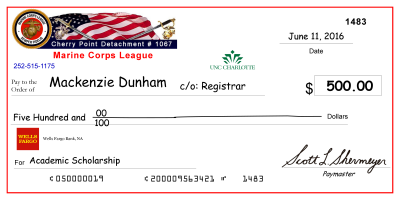 image of large-scale mock check presented to previous scholarship recipient, Mackenzie Dunham